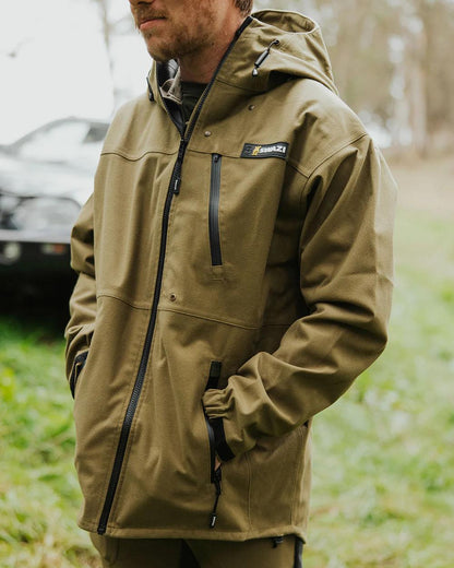 Tussock Green coloured Swazi The Ibex Jacket on blurry background 