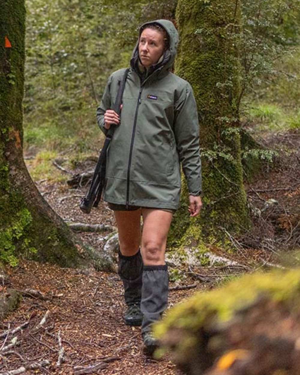 Olive oloured Swazi Womens Pioneer Ultralite Jacket on forest background 