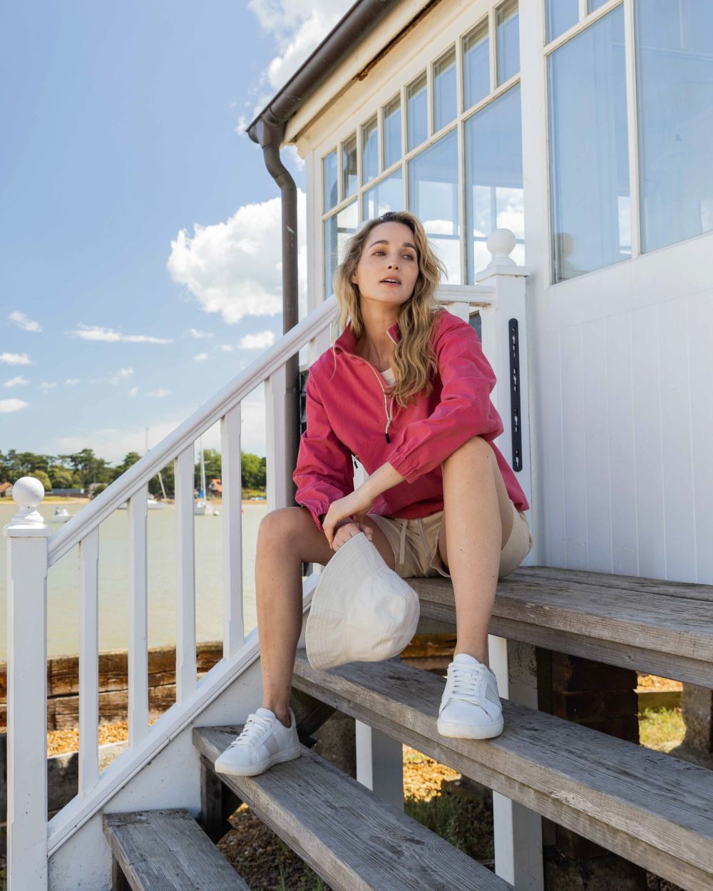 Sweet Raspberry Coloured Musto Womens Falmouth Anorak Jacket On A Beach Background 