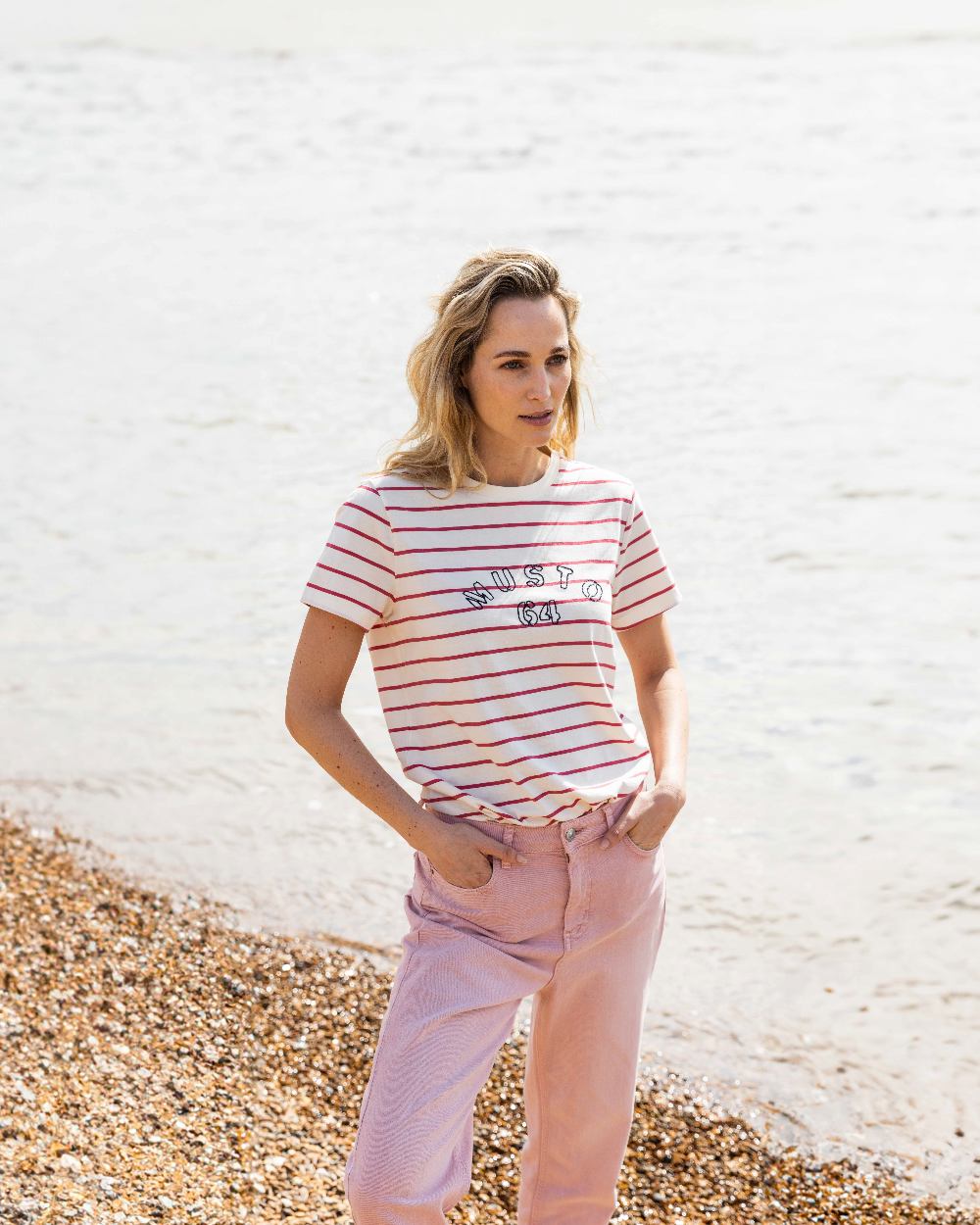 Sweet Raspberry/ASW Coloured Musto Womens Classic Striped Short Sleeve T-Shirt On A Beach Background 