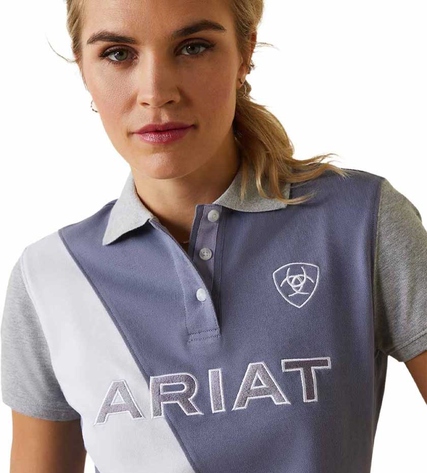 Woman in Ariat Polo shirts on a white background.