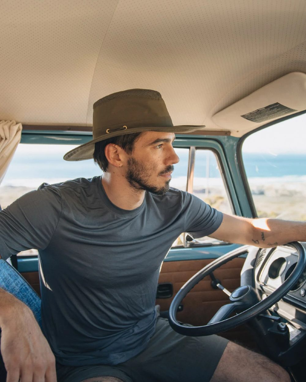 Olive Coloured Tilley Airflo Broad Brim Sun Hat on car background 