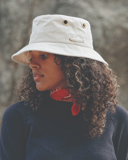 White coloured Tilley Iconic T1 Bucket Hat on blurry background 