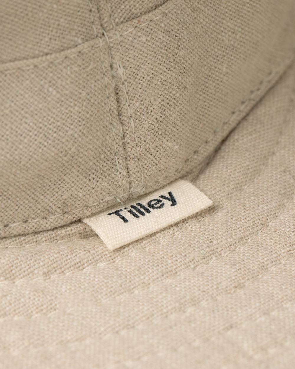 Sand Coloured Tilley TMH55 Organic Airflo Sun Hat on white background 