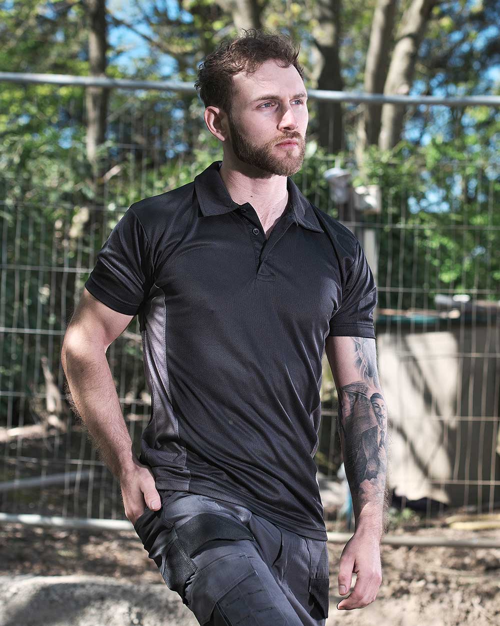 Black Coloured TuffStuff Elite Polo Shirt On A Street Background 