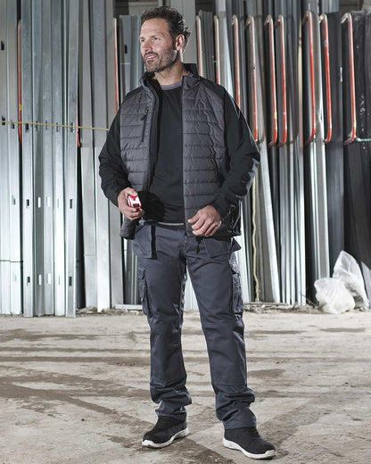 Workman wearing TuffStuff Snape Softshell Jacket with quilted front 