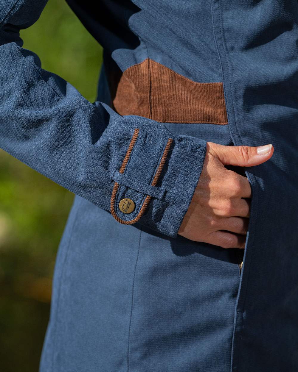 Navy Blue Coloured Baleno Harmony Waterproof Coat on blurry background 