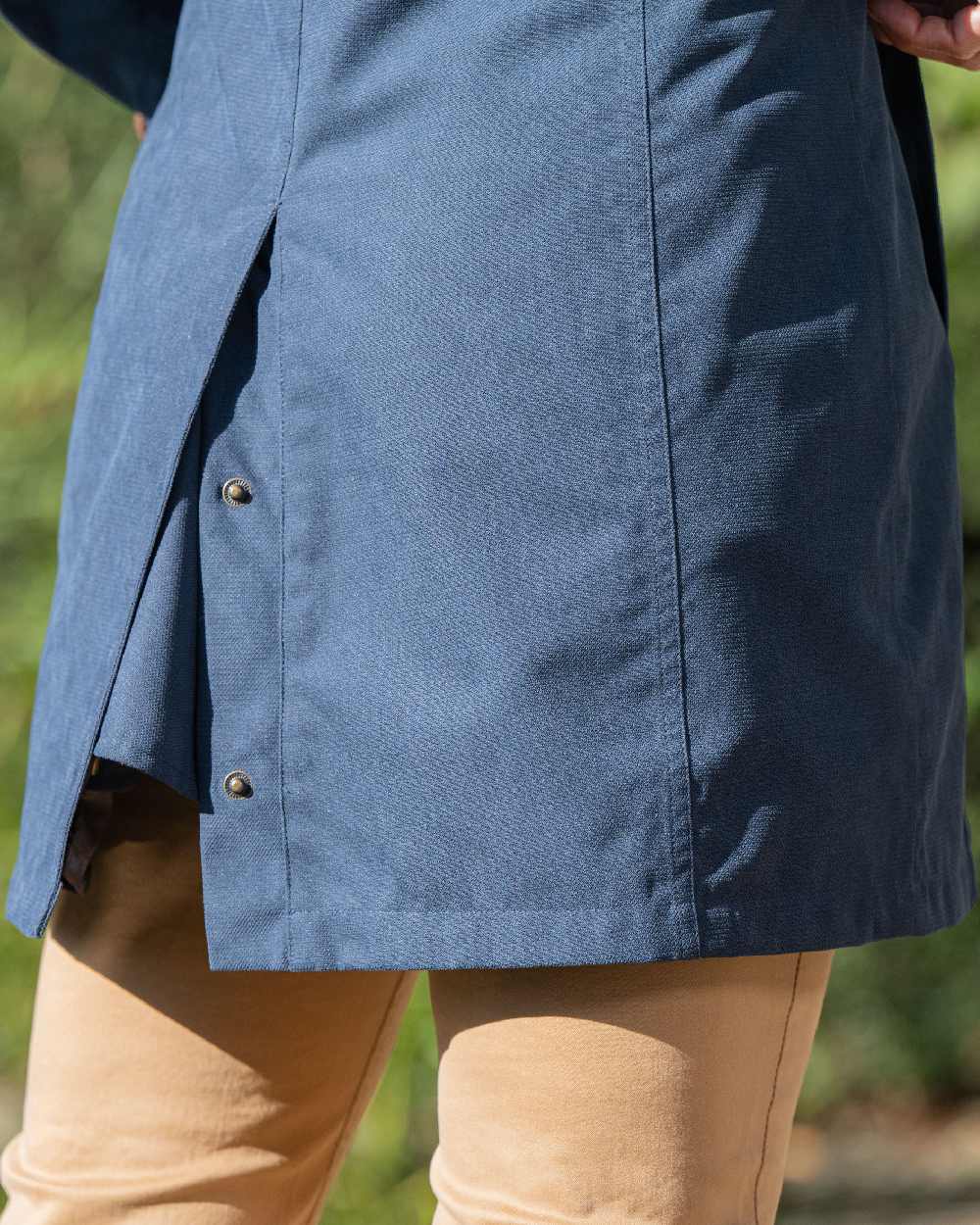 Navy Blue Coloured Baleno Harmony Waterproof Coat on blurry background 