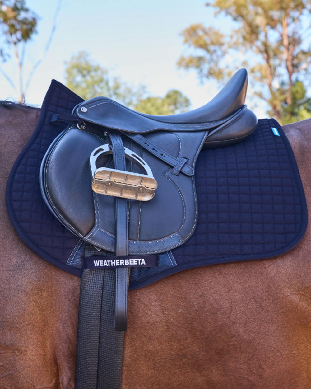 Navy Coloured WeatherBeeta Prime Air-Tec All Purpose Saddle Pad on horse background 