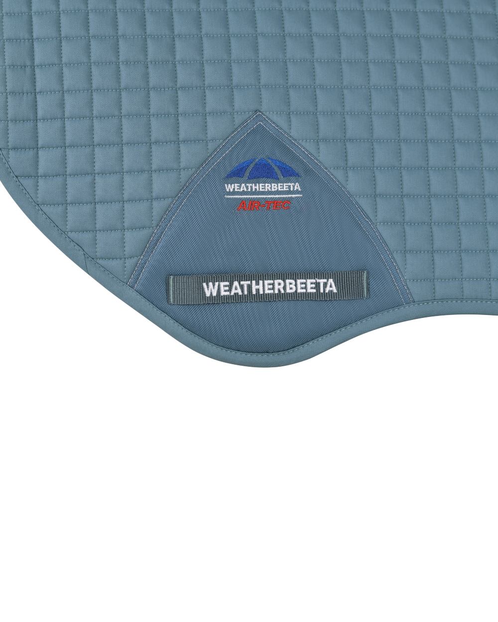 Washed Denim Coloured WeatherBeeta Prime Air-Tec Jump Shaped Saddle Pad on white background 
