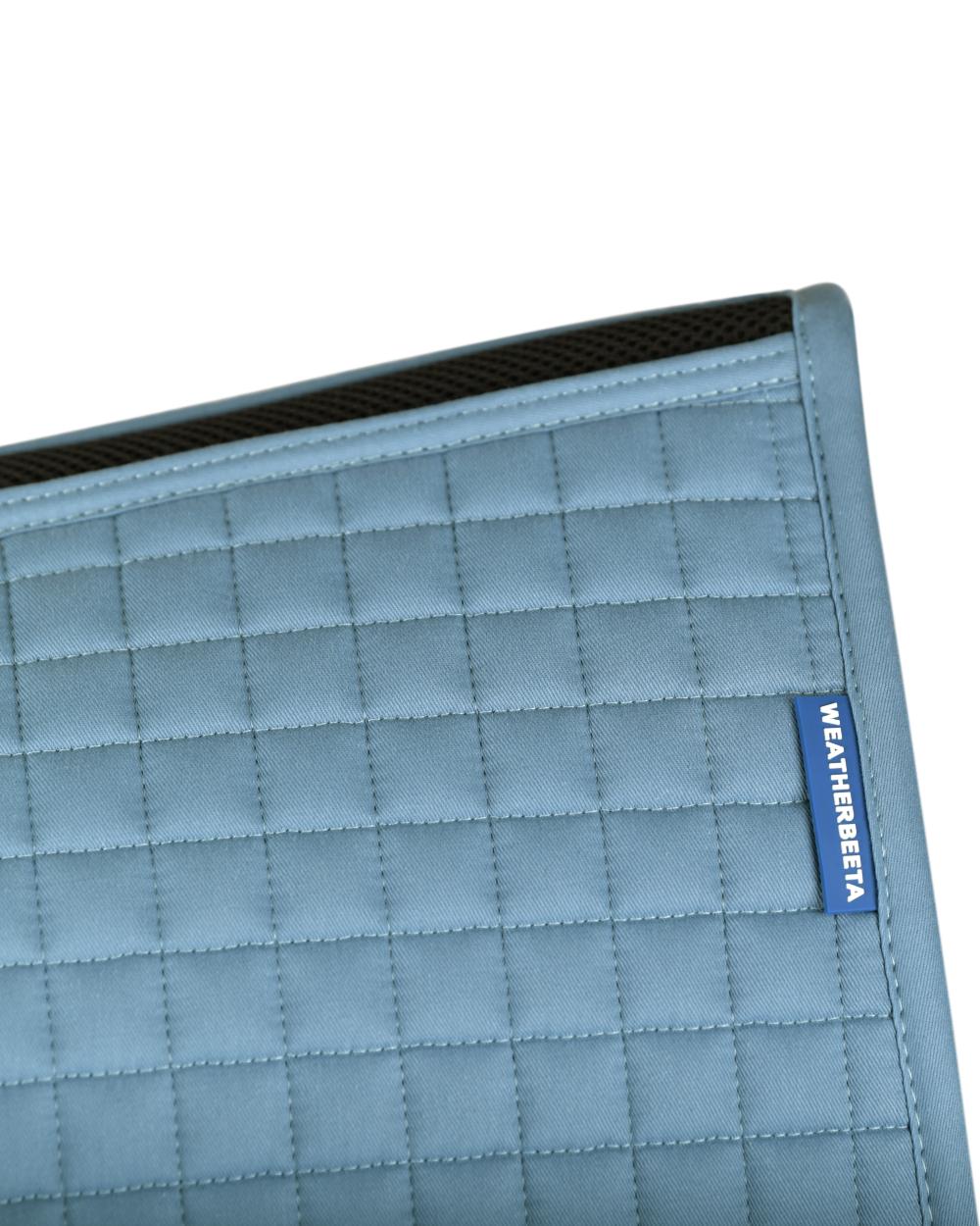 Washed Denim Coloured WeatherBeeta Prime Air-Tec Jump Shaped Saddle Pad on white background 