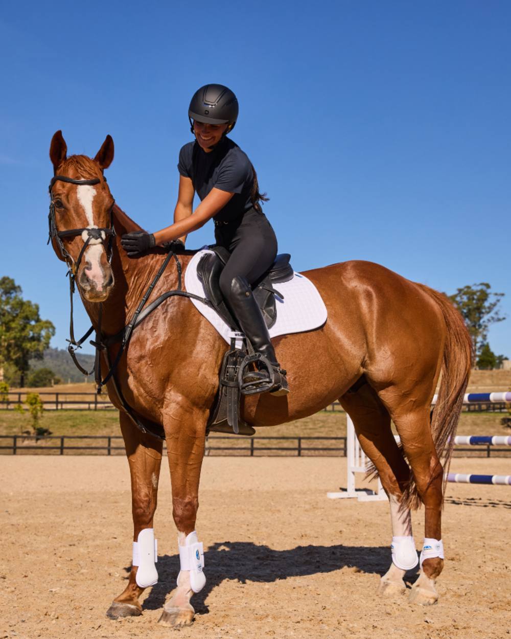 White Coloured WeatherBeeta Prime Air-Tec Jump Shaped Saddle Pad on horse background 