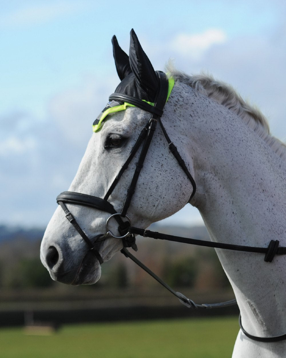 Yellow coloured WeatherBeeta Reflective Ear Bonnet on field background 