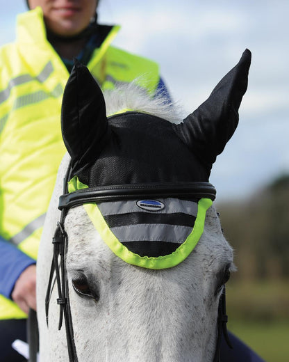 Yellow coloured WeatherBeeta Reflective Ear Bonnet on field background 