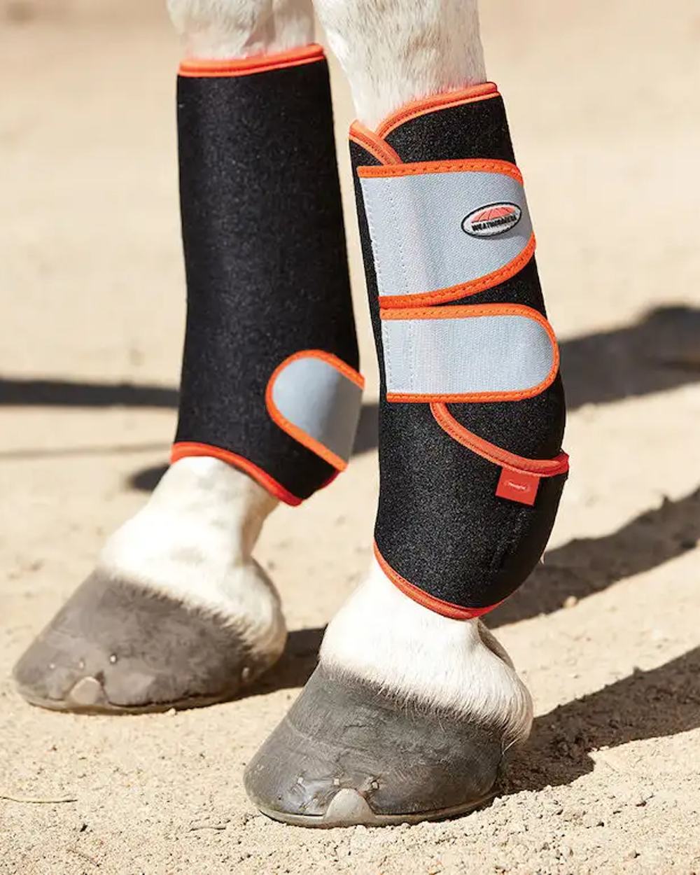 Black Silver Red coloured WeatherBeeta Therapy-Tec Sports Boots on track background 