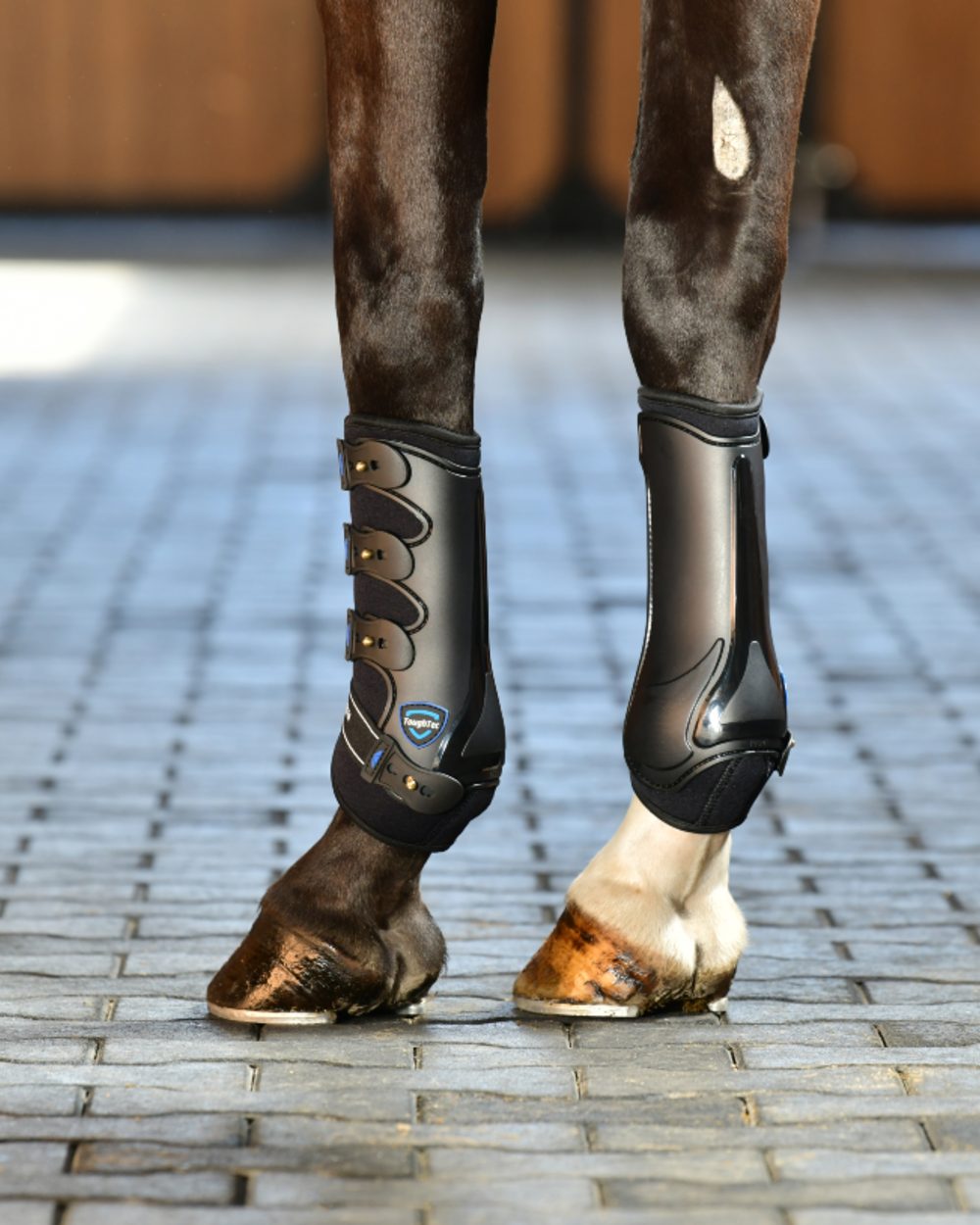Black Coloured WeatherBeeta Tough-Tec Hard Shell Dressage Boots on horse background 