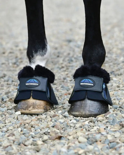 Black Coloured WeatherBeeta Tough-Tec Impact Fleece Trim Bell Boots on horse background 