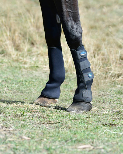 Black Blue Coloured WeatherBeeta Tough-Tec Turnout Boots on horse background 