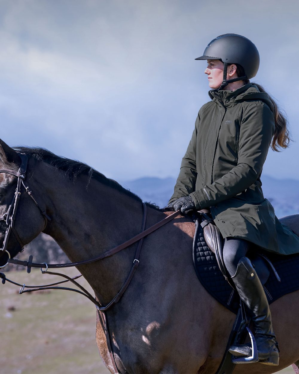 Midnight Green Coloured WeatherBeeta Womens All Purpose Waterproof Longline Equestrian Jacket on outdoor background 