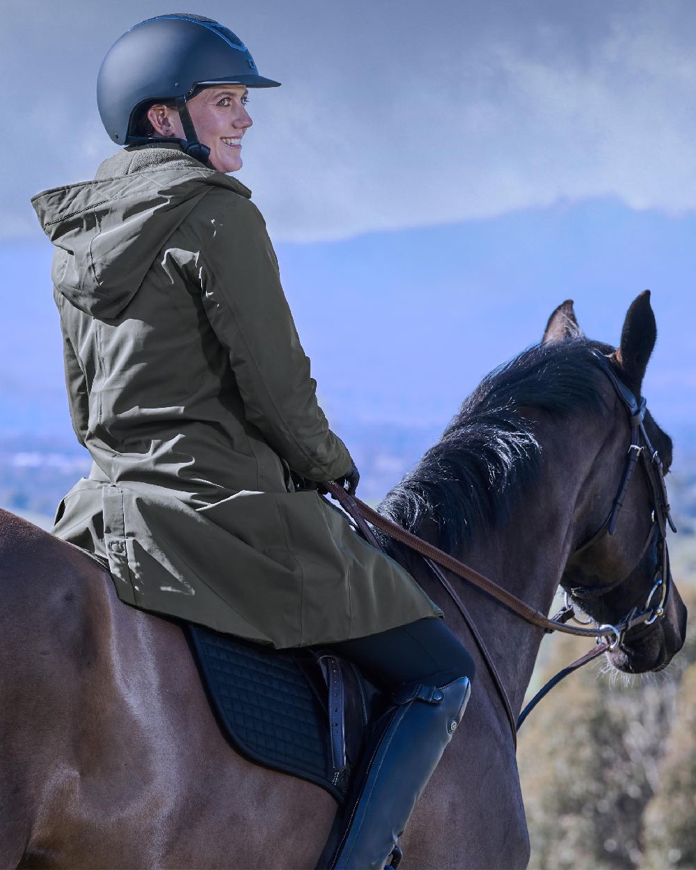 Midnight Green Coloured WeatherBeeta Womens All Purpose Waterproof Longline Equestrian Jacket on outdoor background 