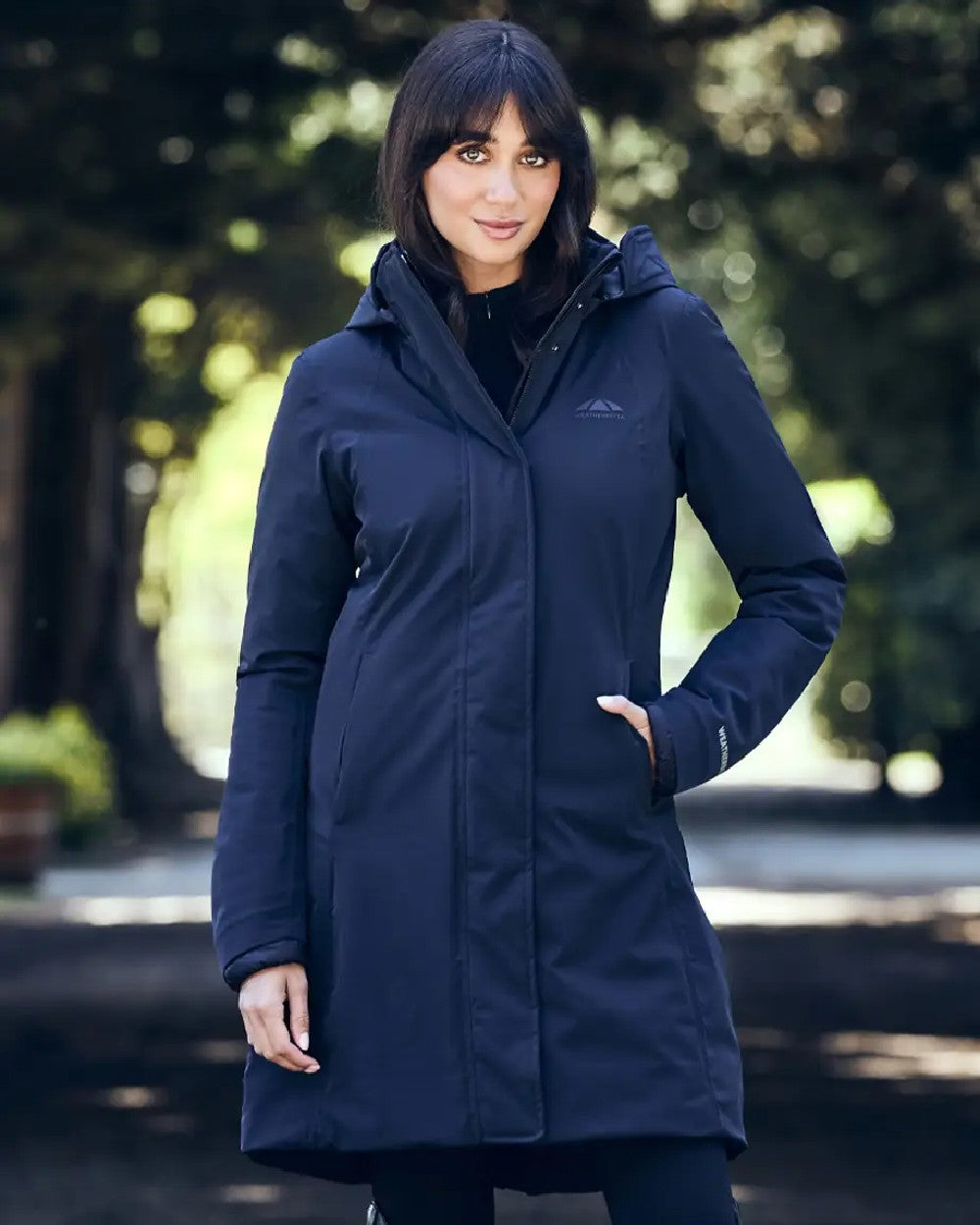 Navy Coloured WeatherBeeta Womens All Purpose Waterproof Longline Equestrian Jacket on outdoor background 