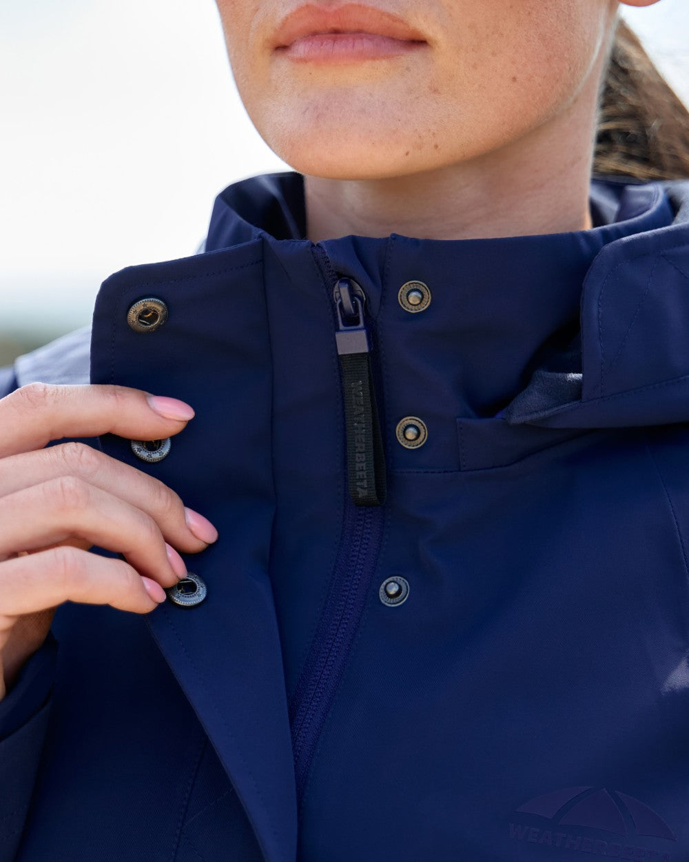 Navy coloured WeatherBeeta Womens Protect Waterproof Riding Jacket on outdoor background 