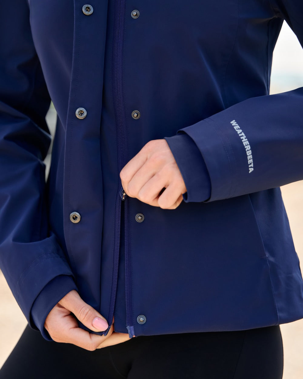 Navy coloured WeatherBeeta Womens Protect Waterproof Riding Jacket on outdoor background 