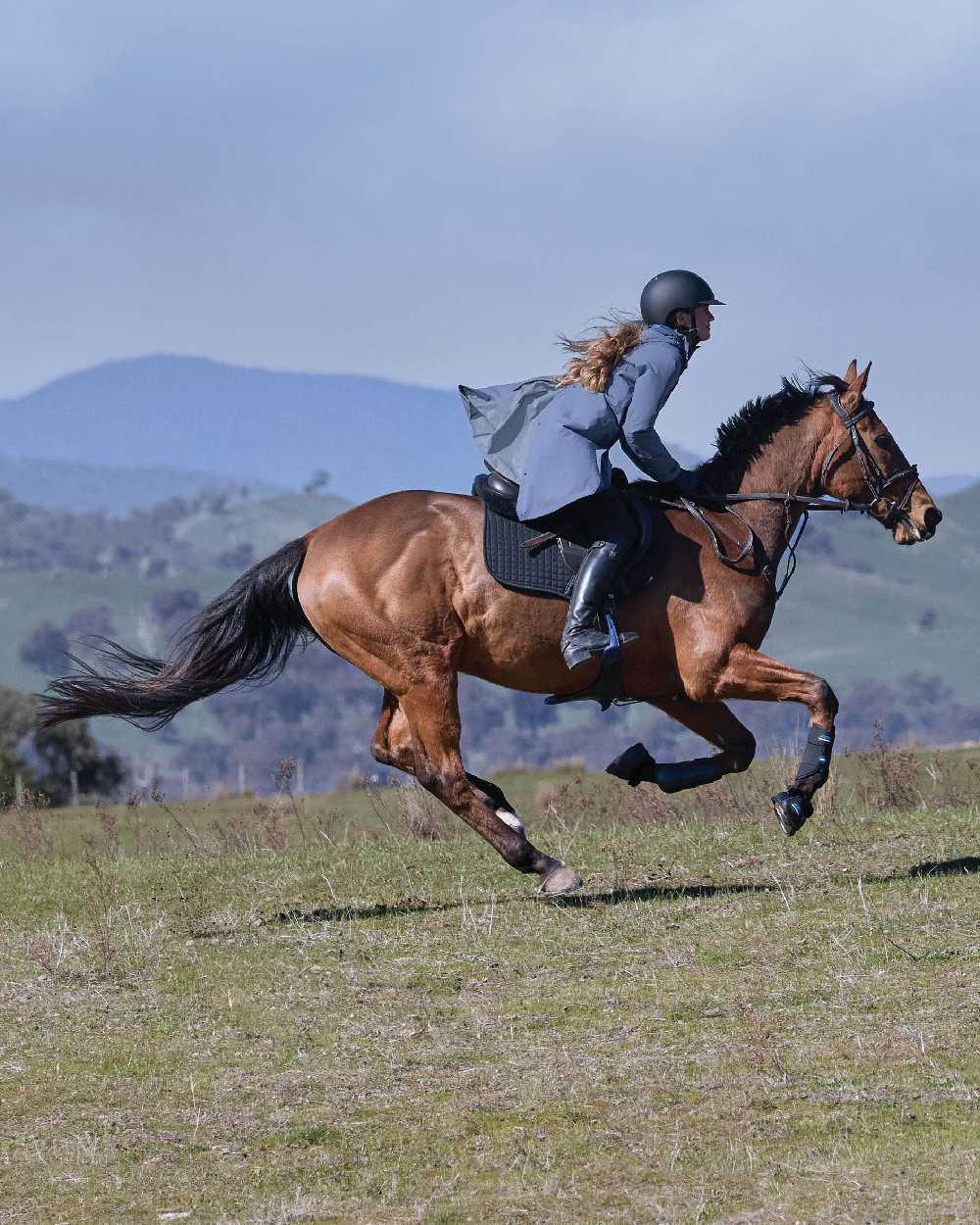 Slate Blue Coloured WeatherBeeta Womens Windbreaker Longline Riding Jacket on outdoor background 
