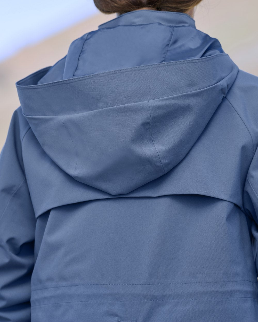 Slate Blue Coloured WeatherBeeta Womens Windbreaker Longline Riding Jacket on outdoor background 
