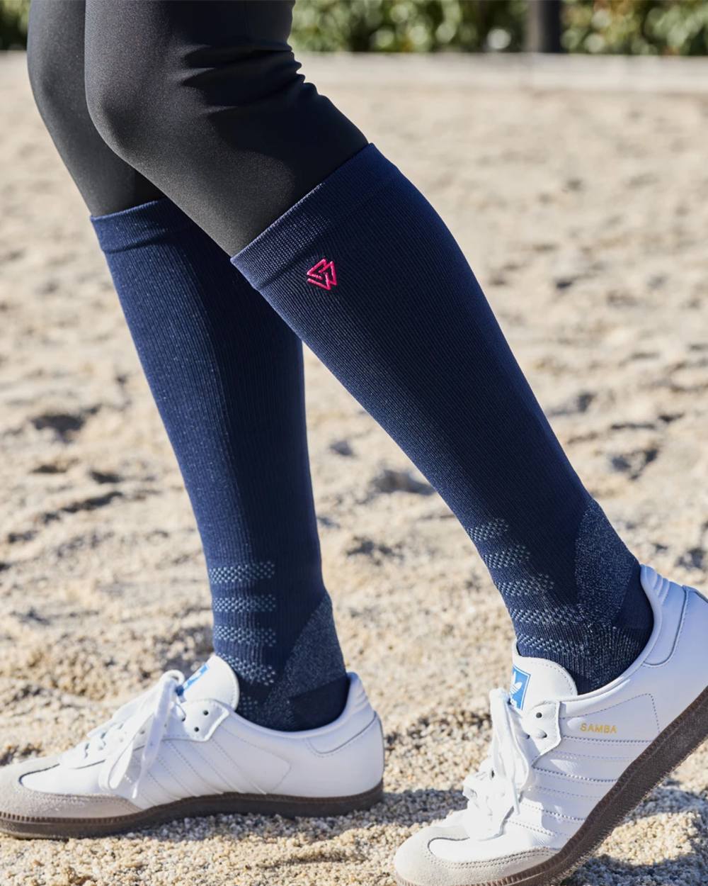 Navy Bright Pink coloured Weatherbeeta Compression Knee Length Riding Socks on ground background 