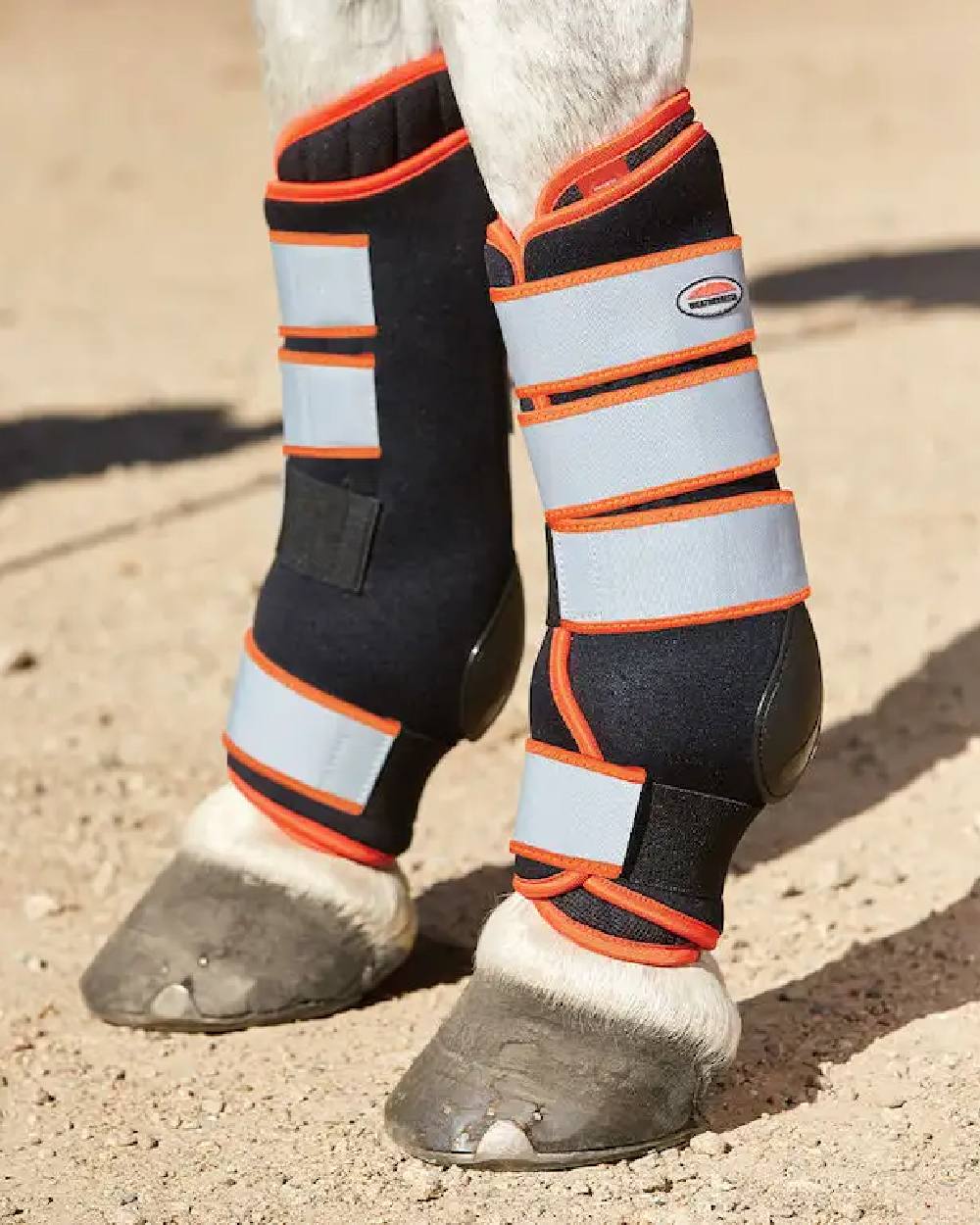 Black Silver Red coloured WeatherBeeta Therapy-Tec Stable Boot Wraps on track background 
