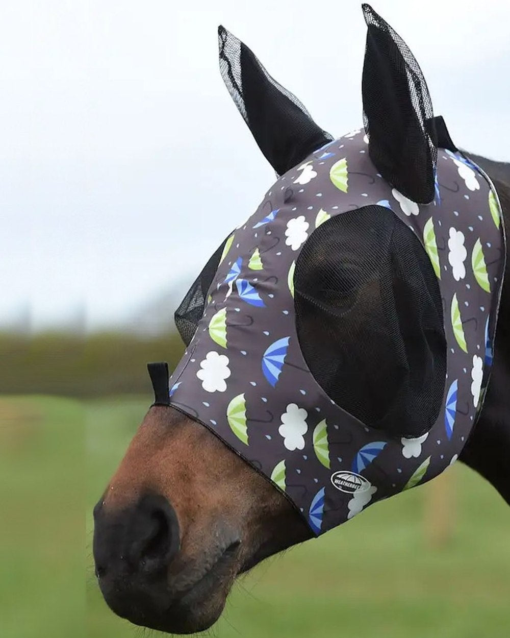 Umbrella Print coloured WeatherBeeta Stretch Bug Eye Saver With Ears on blurry background 