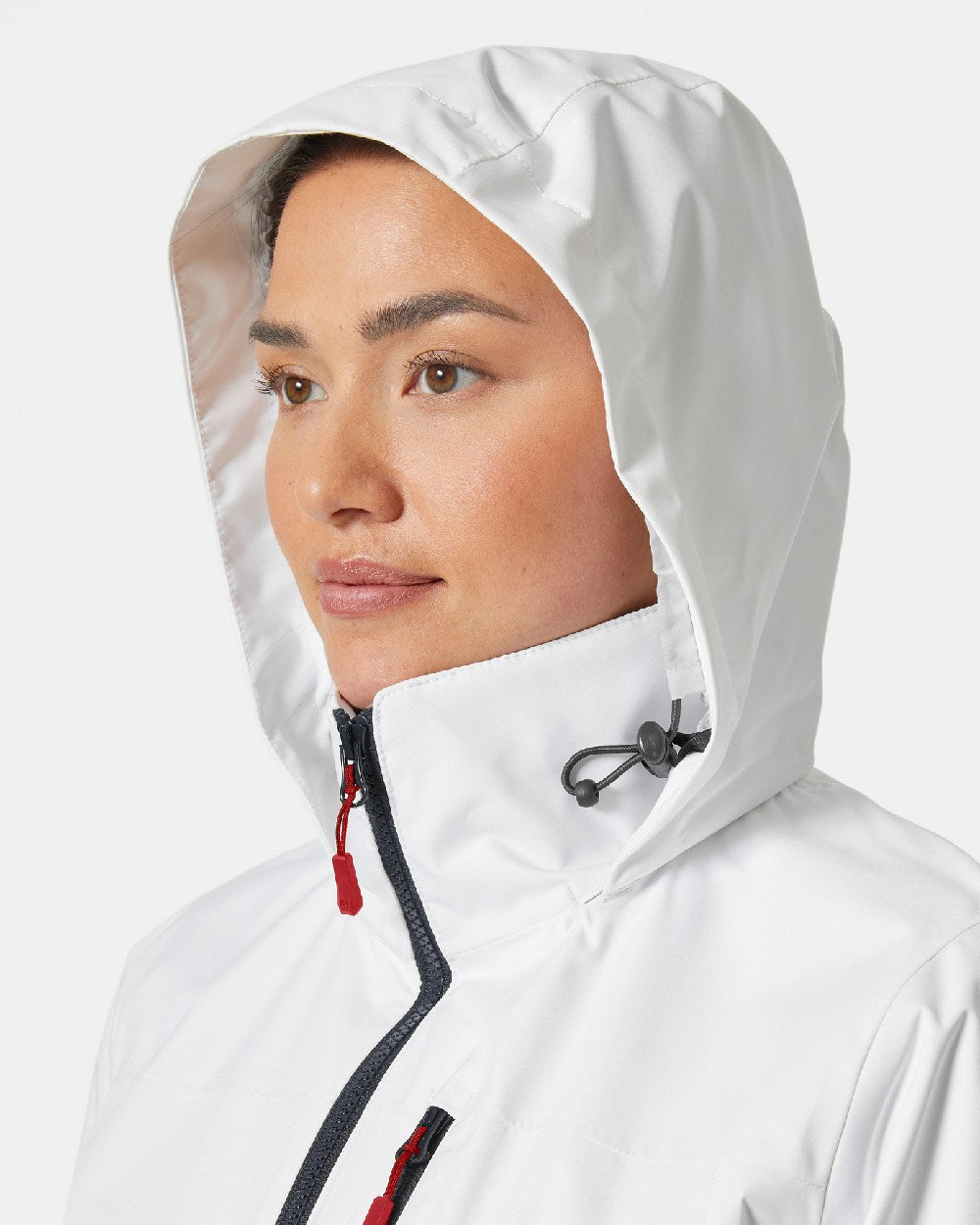 White coloured Helly Hansen womens crew hooded sailing jacket 2.0 on grey background 