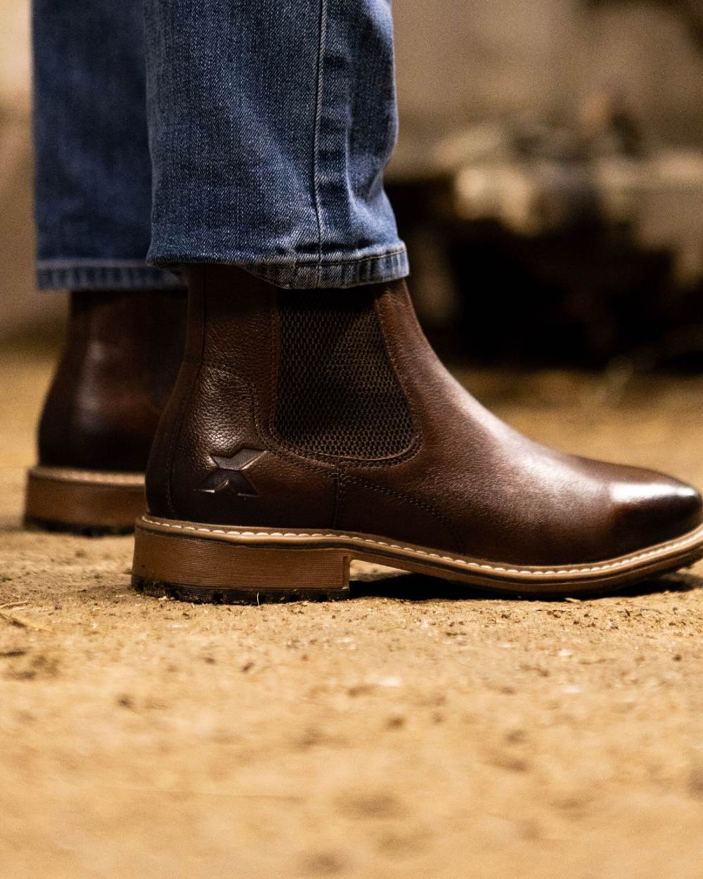 Brown coloured Xpert Mens Heritage Dexter Chelsea Boots on a dusty sandy floor 