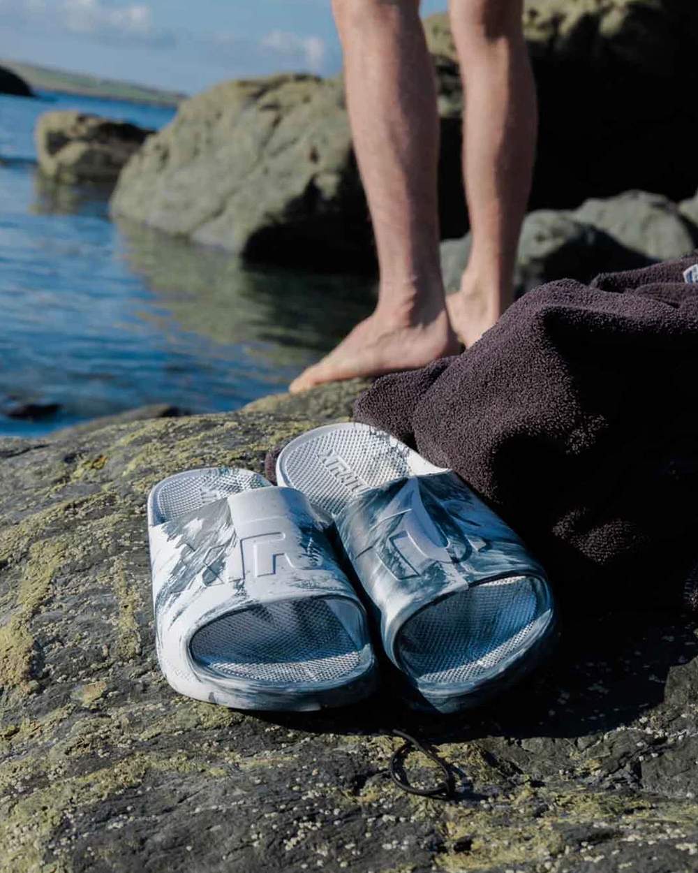 Stormy Coloured Xtratuf Mens Apres Fish Sliders on outdoor background 