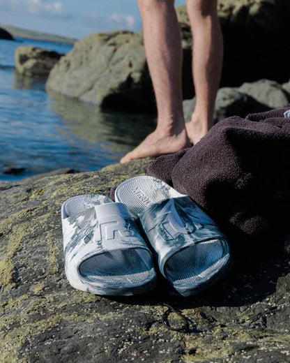 Stormy Coloured Xtratuf Mens Apres Fish Sliders on outdoor background 