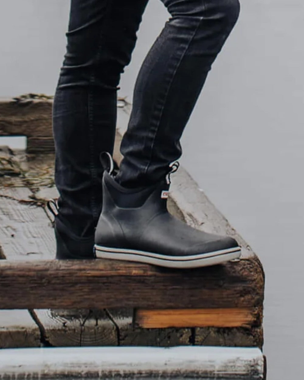 Black Coloured Xtratuf Mens Trolling Pack Fleece Lined Ankle Deck Boots on outdoor background 