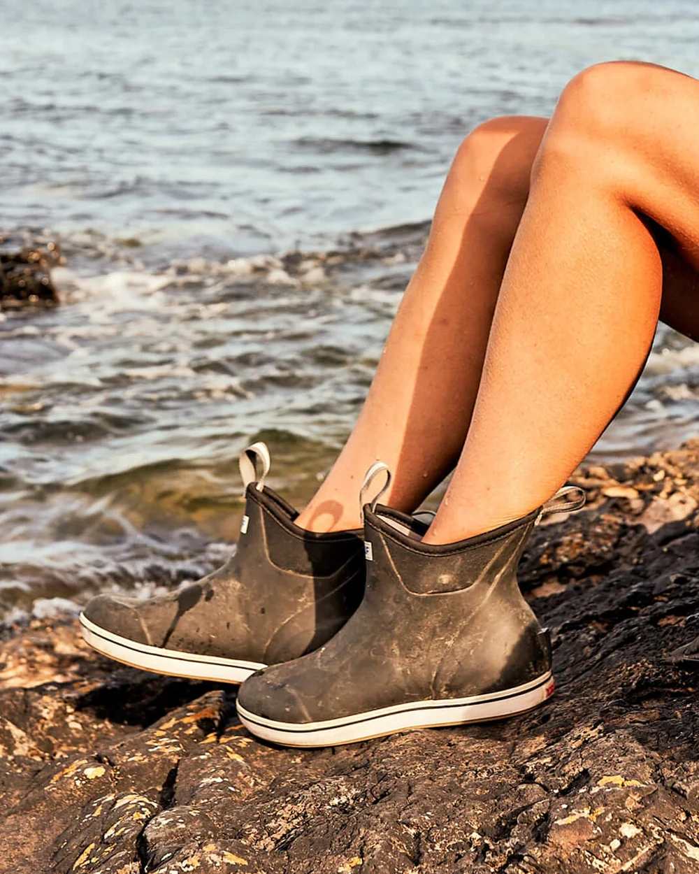 Black Coloured Xtratuf Womens 6" Ankle Deck Boots on outdoor  background 