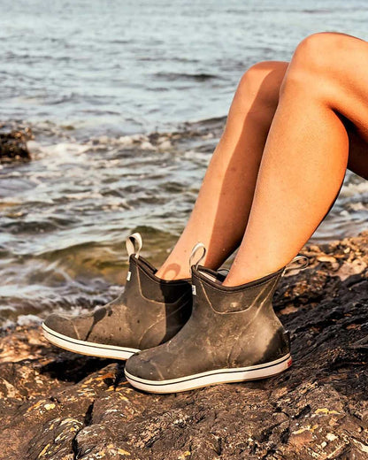 Black Coloured Xtratuf Womens 6&quot; Ankle Deck Boots on outdoor  background 