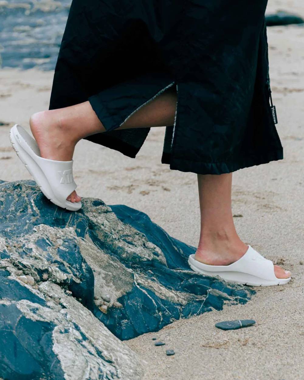 Sand Coloured Xtratuf Womens Apres Fish Sliders on outdoor background 