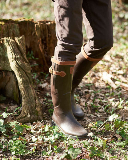 Dark Brown Coloured Aigle Parcours 2 Signature Wellingtons On A Forest Background