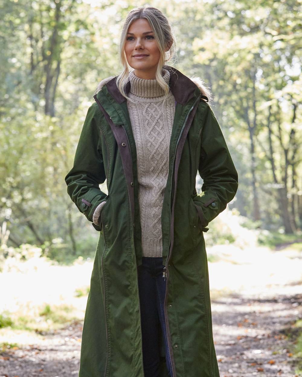 Pesto Coloured Alan Paine Fernley Long Waterproof Coat On A Forest Background 