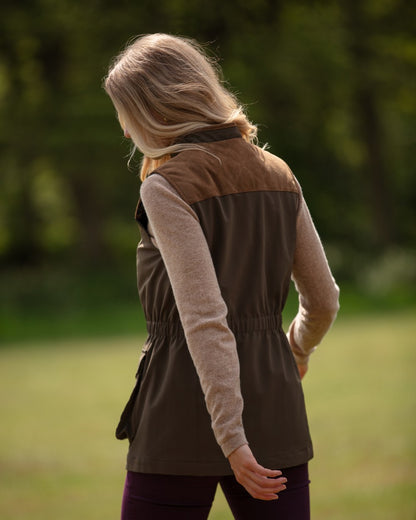 Olive Coloured Alan Paine Ladies Lockwood Shooting Waistcoat On A Forest Background