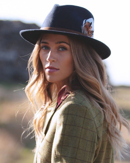 Navy coloured Alan Paine Ladies Richmond Felt Hat on blurry background 