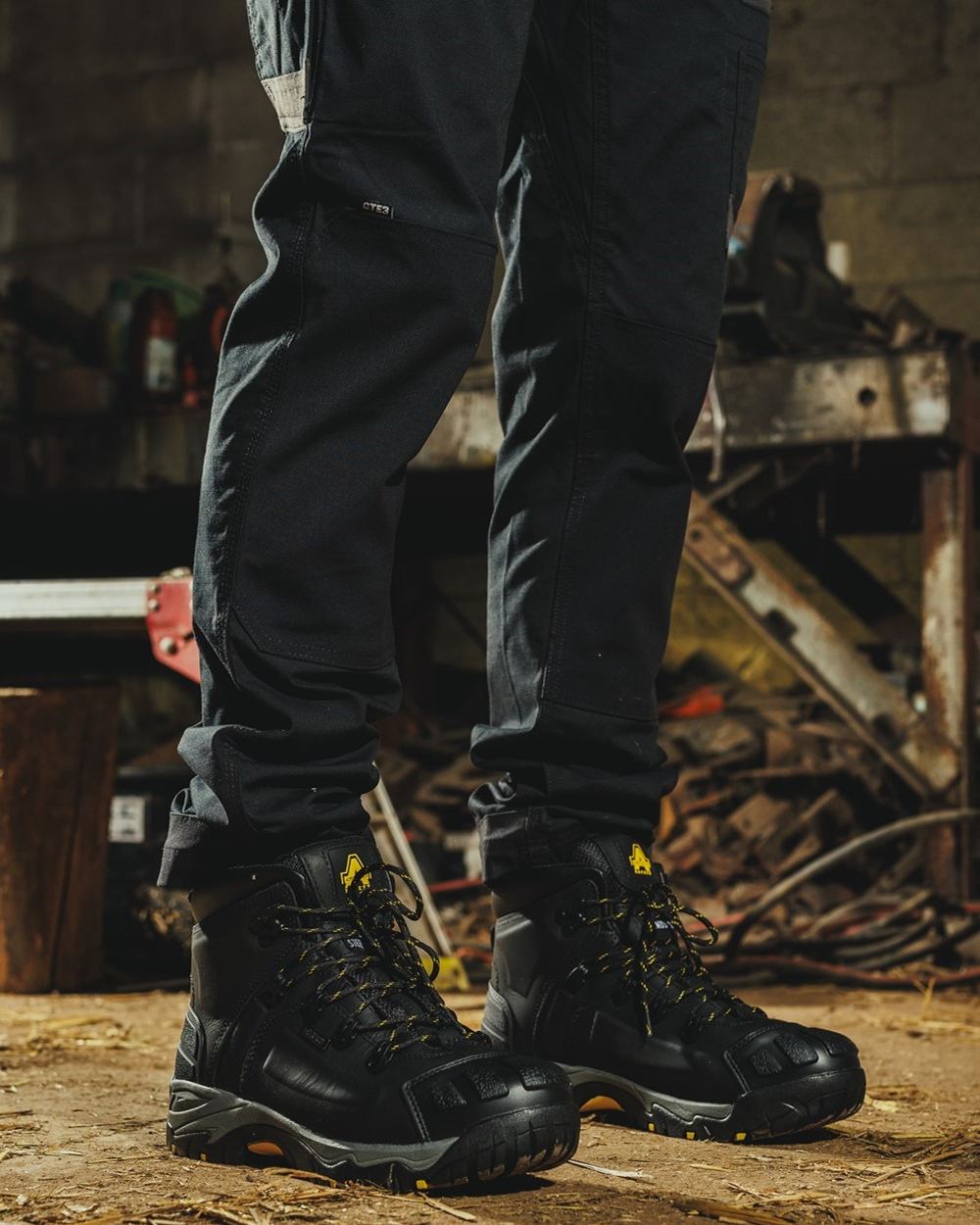 Black Coloured Amblers Safety FS32 Waterproof Safety Boots on a workspace background  