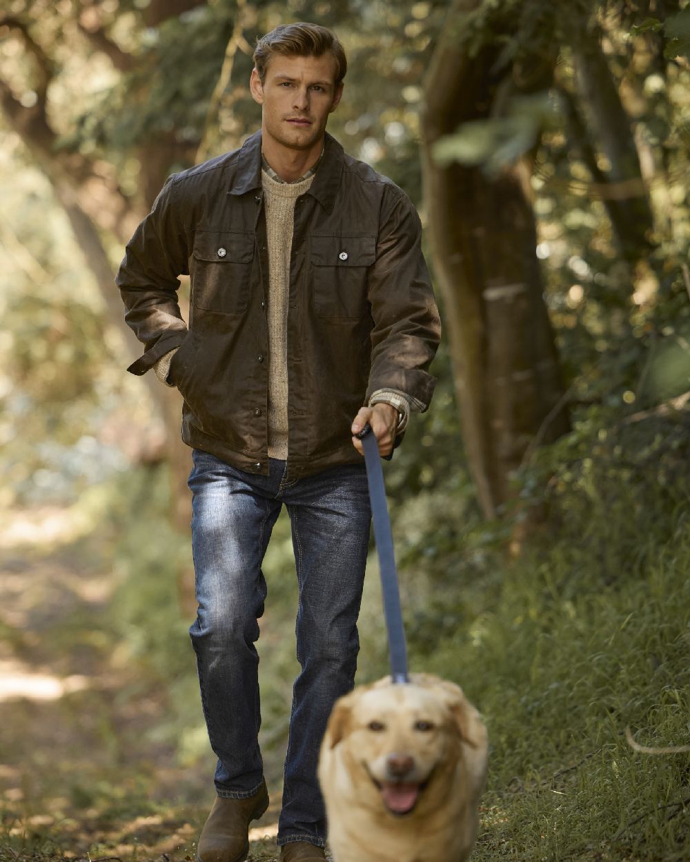 Brown coloured Ariat Mens Drayham Jacket on forest background 