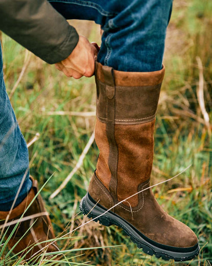 Java Coloured Ariat Moresby Tall H20 Java Country Boot On A Field Background