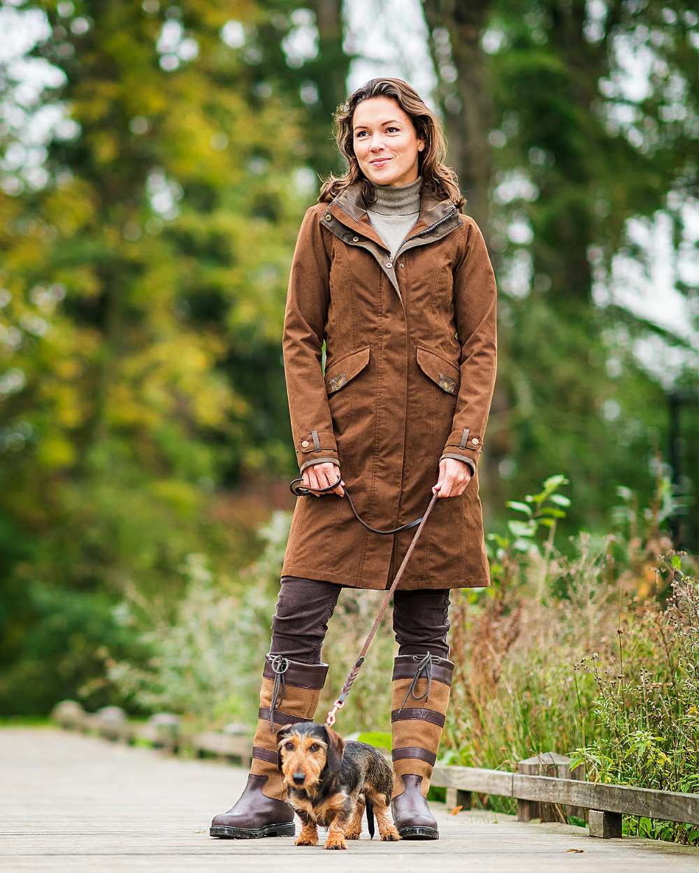Brown Coloured Baleno Chelsea Mid Length Coat on countryside background 
