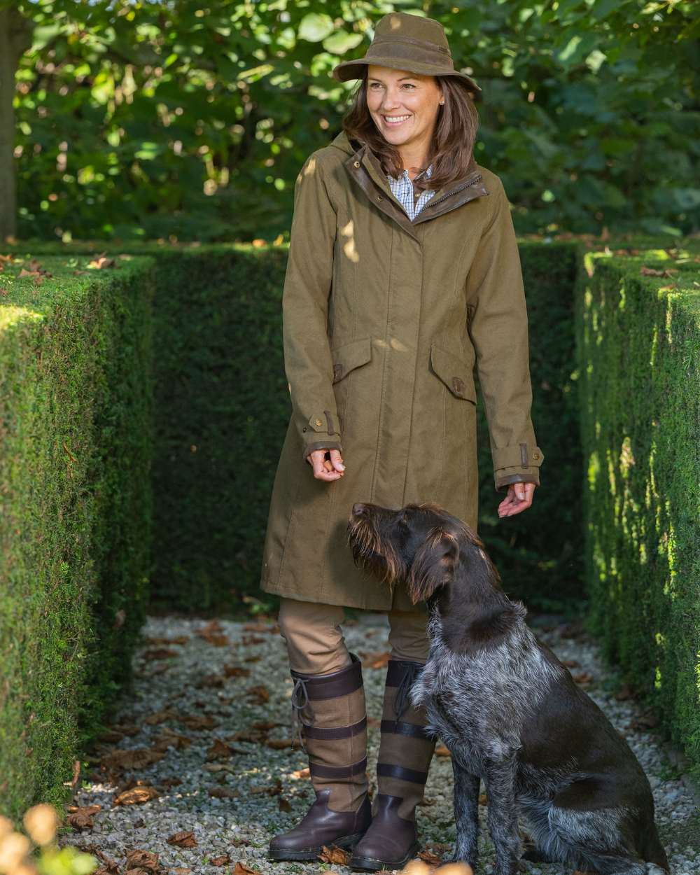 Pine Green Coloured Baleno Chelsea Mid Length Coat on garden background 