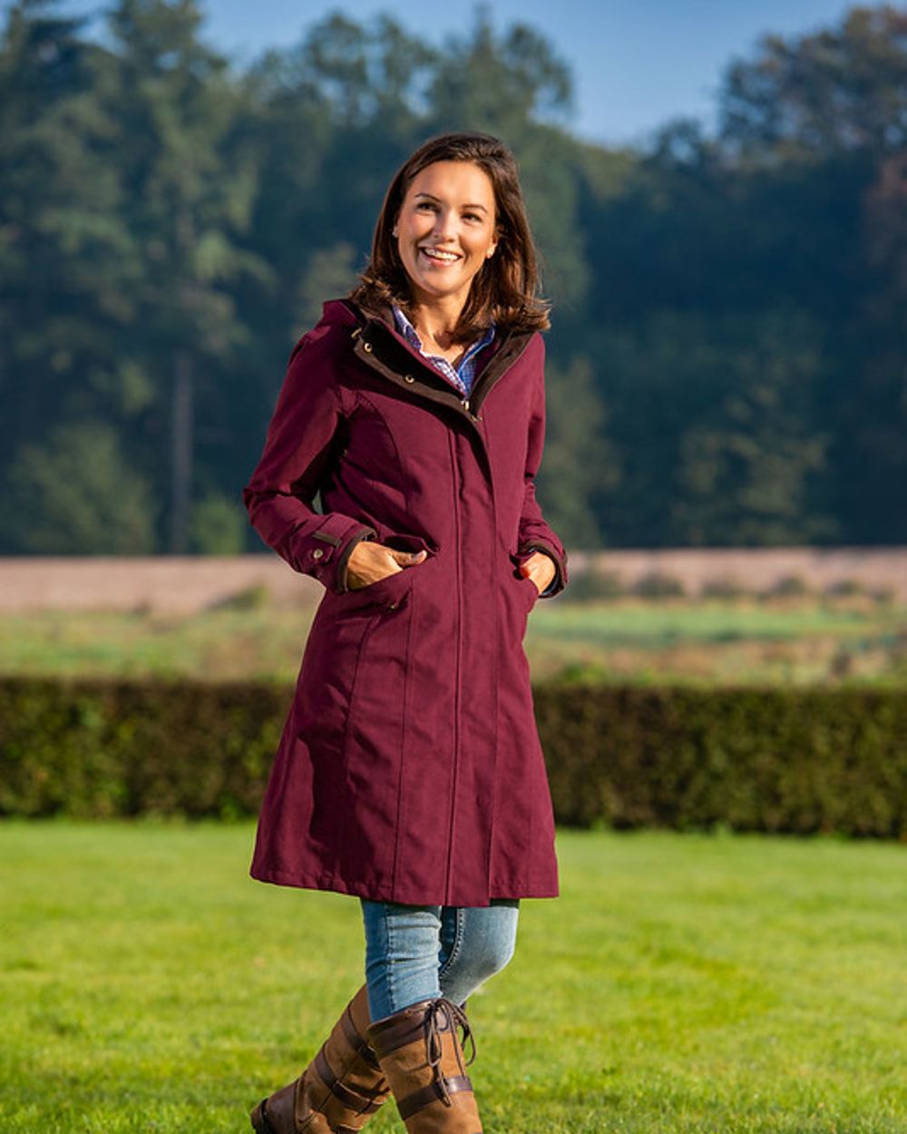 Raspberry Coloured Baleno Chelsea Mid Length Coat on garden background 
